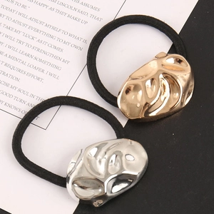 Detail view of gold and silver metallic ponytail holders with elastic bands