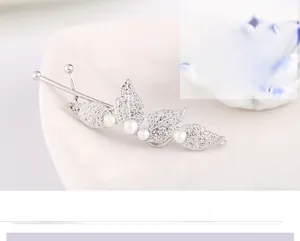 Detailed close-up of a silver leaf-shaped hair clip with elegant white pearls and veins