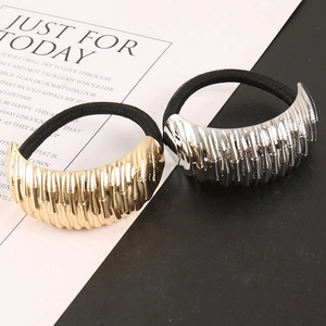 Irregular textured gold and silver metal hair ties set on a minimalist background
