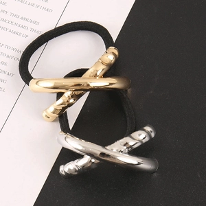 Detail view of gold and silver metallic twisted metal accents on black elastic hair ties