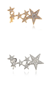 Detailed view of star-shaped ear cuffs set with sparkling rhinestones in gold and silver