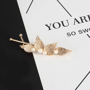 Elegant gold leaf hair pin with white pearls for women in a minimalist fashion design