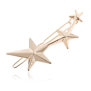 Three gold star hair clips in a curved row with polished metallic finish and back reflection