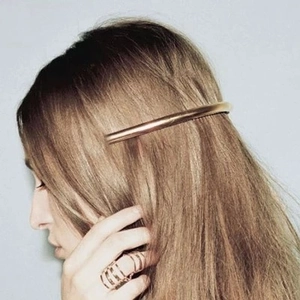 Minimalist gold metal bar hair clip shown on long hair with a polished finish