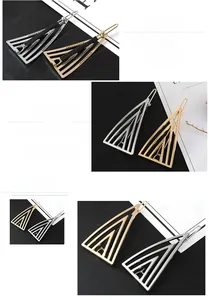Detail of geometric triangle hair clips in gold and silver finish with hollow design