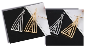 Detail view of geometric triangle hair clips in polished gold and silver finishes