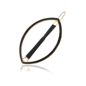 Minimalist gold metal marquise hair clip with black enamel trim and leather wrap detail