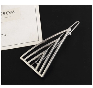 Close-up of silver geometric hollow triangle hair clip with a polished alloy finish