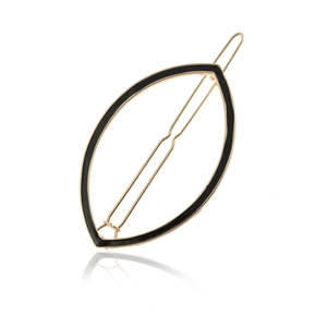 Minimalist gold alloy leaf hair clip with black enamel finish on white background
