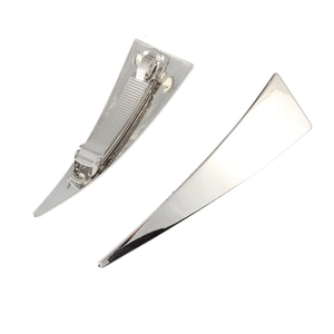 Detailed macro view of silver polished triangle hair clips showing front and back metal clip