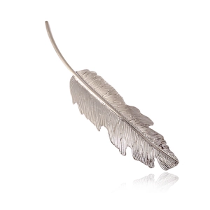 Detail of silver leaf hair clip with fine brushed metal texture and feather carving