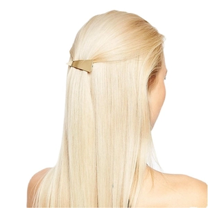Golden geometric trapezoid metal hair clip elegantly worn on straight blonde hair