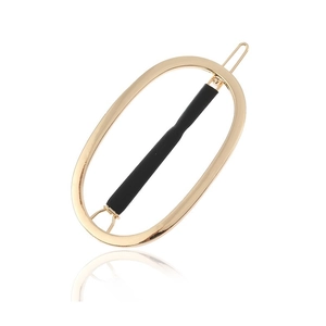 Barrette à cheveux ovale dorée minimaliste avec fini lisse et prise antidérapante noire