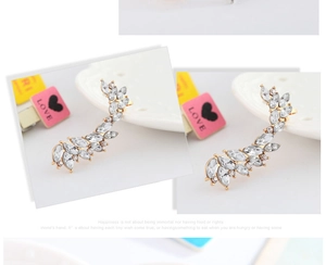 Dettaglio di orecchino a clip con cristalli marquise dorati e design a foglia elegante