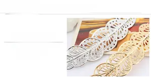Detail of hollow leaf hair clip showing polished gold and silver mirror finish metal texture