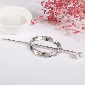 Détail d'épingle à cheveux argentée avec ovale évidé brossé et pendentif perle