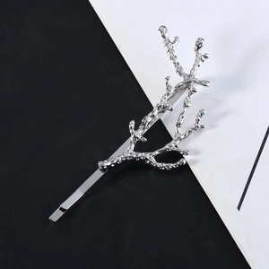 Minimalist silver metal hair clip in branch shape with textured liquid metal finish