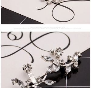 Detail view of silver crystal leaf earrings with marquise and round cubic zirconia stones