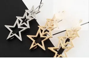 Polished metal star hair clips in gold and silver showing hollow pentagon designs