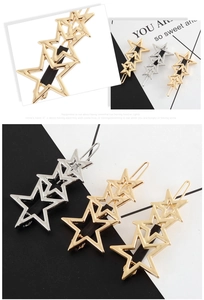 Macro shot of polished hollow star hair clips in gold and silver finish options