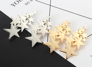 Close-up of gold and silver metallic star cluster hair clips with polished finish