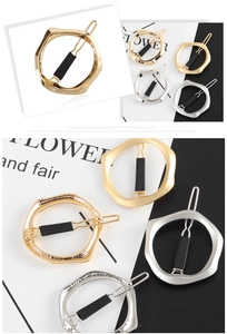 Detailed view of geometric metal hair clips in polished gold, silver, and matte finishes