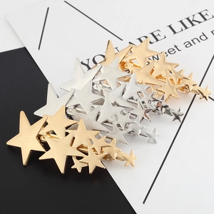 Polished metal pentagram hair clips in gold and silver with tiered star shower design