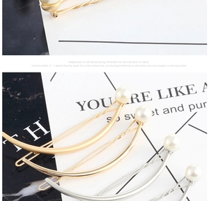 Close-up of matte metal bow hair clips with white pearls in gold and silver finish
