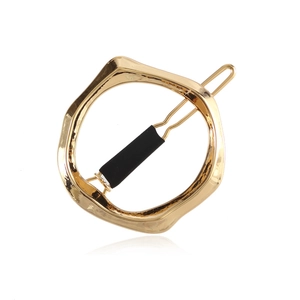 Minimalist irregular geometric round hair clip with hammered gold finish and black bar