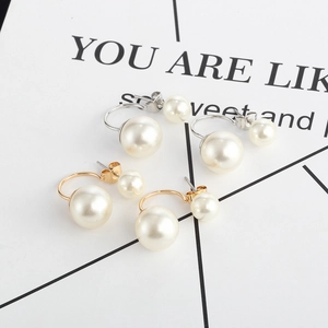 Classic double-sided pearl drop earrings set in gold and silver minimalist finishes