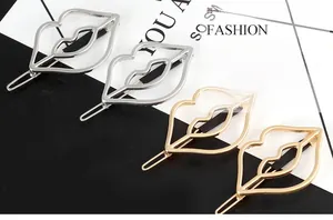 Detail of hollow lip-shaped hair clips in polished gold and silver alloy metal finish