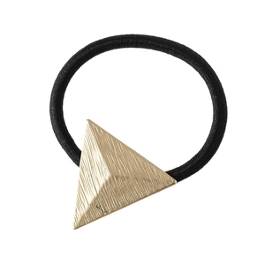 Detail of matte gold triangle hair tie featuring a brushed metal texture and black elastic cord