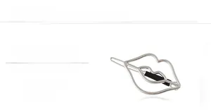Detailed macro view of silver mirror-finish hollow lip-shaped metal hair clip