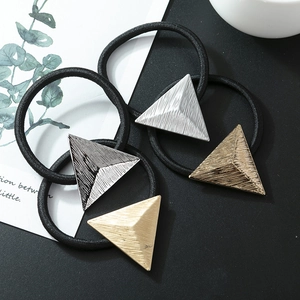 Set of four elastic hair ties with textured matte metal triangle charms in assorted colors