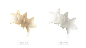 Detail view of interlocking star hair clips in matte gold and matte silver finishes