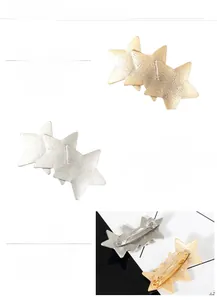 Detail of mirror-polished metal star hair clip with high-quality gold plating finish