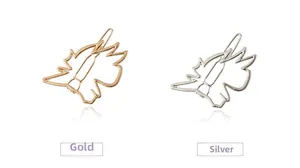 Detail view of geometric metal hair clips in polished gold and silver finishes