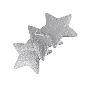 Detailed macro of interlocking silver stars hair clip with a hammered metal texture finish