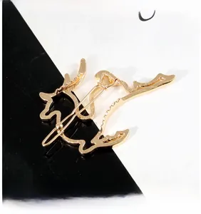Close-up of a golden hollow deer hair clip with a sleek metal alligator clasp back