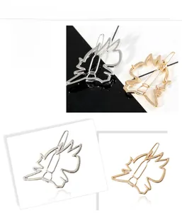 Close-up of geometric hollow metal hair clips in polished gold and silver finishes