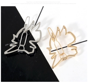 Detail view of hollow geometric anime horse head hair clips in gold and silver finishes