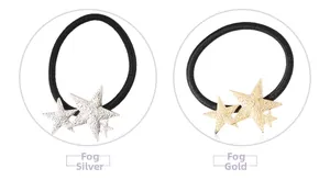 Detail showing matte silver and matte gold star charms on elastic hair ties