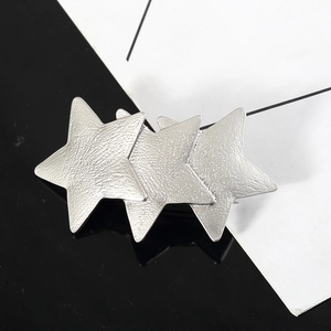 Minimalist silver matte star hair clip with three interlocking stars in modern design