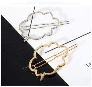 Detail view of gold and silver hollow cloud-shaped alloy hair clips with polished finish