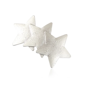 Silver metallic pentagram hair clips with textured hammered finish on white background