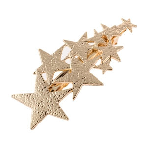 Close-up of golden star hair clip with hammered metal texture and multiple star shapes