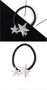 Close-up of black elastic hair ties with textured silver stars on a monochrome background