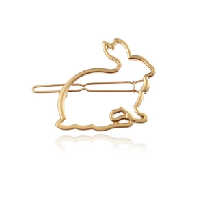 Close-up of golden hollow rabbit-shaped metal hair clip with a minimalist design