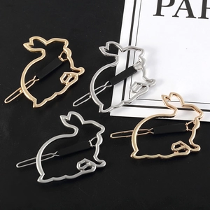 Detailed view of hollow metal rabbit hair clips in elegant gold and silver plated finish