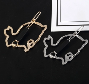 Detail of hollow bunny hair clips in gold and silver finish with secure metal backing